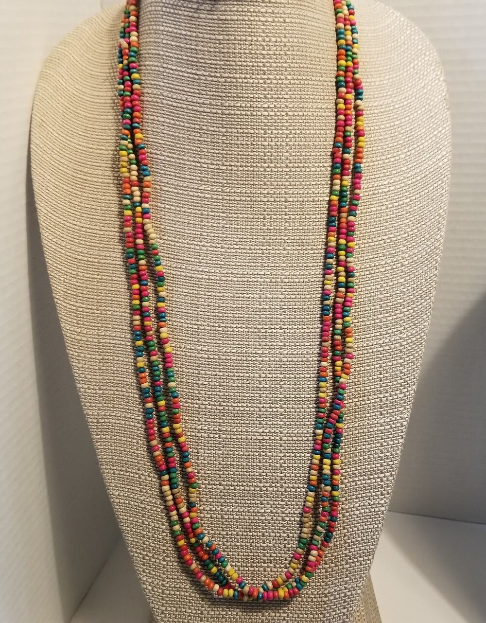 Three colorful 34" strands of light weight tiny wood beads strung on string